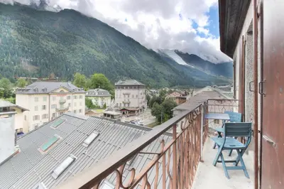 a chair on a balcony with a view of a mountain at Nook 40 - Les Balances - Central Mont-Blanc views in Chamonix-Mont-Blanc