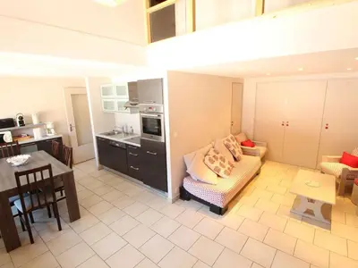 a kitchen and a living room with a couch and a table at Appartement Duplex 4 pièces pour 6 pers, sur les pistes avec WiFi et parking, proche commerces - FR-1-572-62 in Arâches-la-Frasse