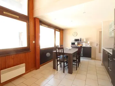 a kitchen with a table and chairs in a room at Appartement Duplex 4 pièces pour 6 pers, sur les pistes avec WiFi et parking, proche commerces - FR-1-572-62 in Arâches-la-Frasse