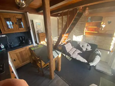 a living room with a couch and a table at Appartement face Mont Blanc in Demi-Quartier