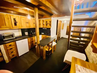 a kitchen and dining room with a table and chairs at Appartement face Mont Blanc in Demi-Quartier
