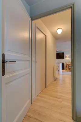 a hallway with a door leading to a kitchen at Apartment Fermes du Montenvers B2- Alpes Travel - Central Chamonix (sleeps 4-5) in Chamonix-Mont-Blanc