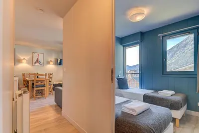 a room with two beds and a dining room at Apartment Fermes du Montenvers B2- Alpes Travel - Central Chamonix (sleeps 4-5) in Chamonix-Mont-Blanc