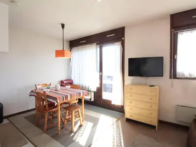a dining room with a table and chairs and a television at Studio 4 pers à 100m des pistes, proche commerces - FR-1-572-219 in Arâches-la-Frasse