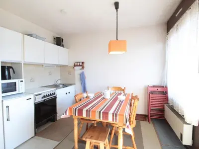 a kitchen with a table and chairs in a room at Studio 4 pers à 100m des pistes, proche commerces - FR-1-572-219 in Arâches-la-Frasse
