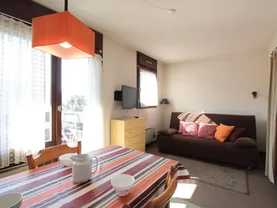 a living room with a table and a couch at Studio 4 pers à 100m des pistes, proche commerces - FR-1-572-219 in Arâches-la-Frasse