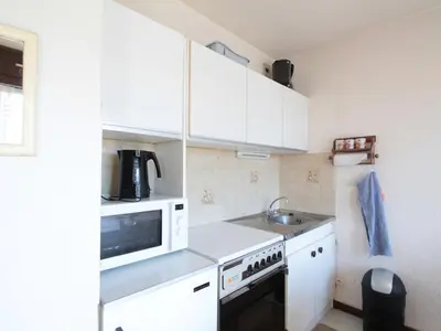 a small kitchen with white cabinets and a microwave at Studio 4 pers à 100m des pistes, proche commerces - FR-1-572-219 in Arâches-la-Frasse