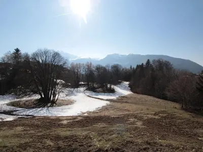 a snow covered field with trees and a river at Studio 4 pers à 100m des pistes, proche commerces - FR-1-572-219 in Arâches-la-Frasse
