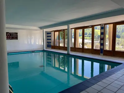 a large swimming pool with blue water at Apartment Joly-Vue in Saint-Gervais-les-Bains