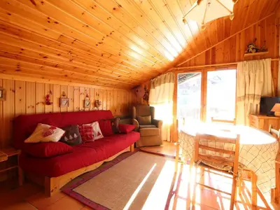 a living room with a red couch and a table at Appartement Mansardé 3 Pièces, 6 Pers, Balcon Sud-Est, Garage, Proche Centre et Pistes - FR-1-572-147 in Arâches-la-Frasse