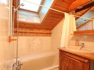 a bathroom with a bath tub and a sink at Appartement Mansardé 3 Pièces, 6 Pers, Balcon Sud-Est, Garage, Proche Centre et Pistes - FR-1-572-147 in Arâches-la-Frasse