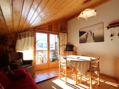 a living room with a couch and a table in a room at Appartement Mansardé 3 Pièces, 6 Pers, Balcon Sud-Est, Garage, Proche Centre et Pistes - FR-1-572-147 in Arâches-la-Frasse