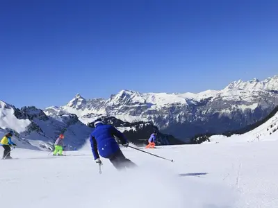 a group of people skiing down a snow covered mountain at Appartement Mansardé 3 Pièces, 6 Pers, Balcon Sud-Est, Garage, Proche Centre et Pistes - FR-1-572-147 in Arâches-la-Frasse