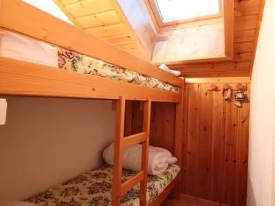 a bedroom with two bunk beds in a cabin at Appartement Mansardé 3 Pièces, 6 Pers, Balcon Sud-Est, Garage, Proche Centre et Pistes - FR-1-572-147 in Arâches-la-Frasse