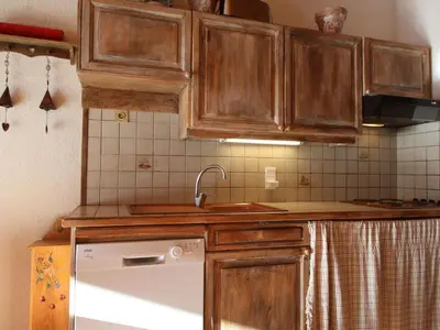 a kitchen with wooden cabinets and a sink at Appartement Mansardé 3 Pièces, 6 Pers, Balcon Sud-Est, Garage, Proche Centre et Pistes - FR-1-572-147 in Arâches-la-Frasse