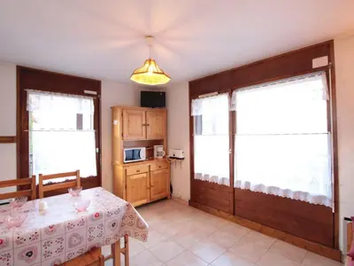 a dining room with a table and a kitchen at Studio central village aux Carroz, animaux admis, 5 pers - FR-1-572-202 in Arâches-la-Frasse