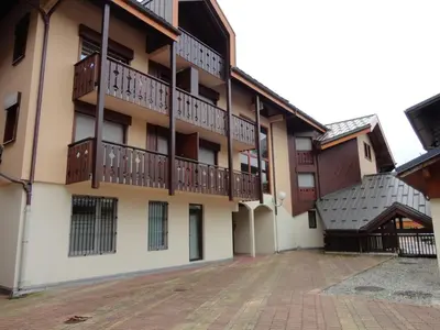 an apartment building with balconies and a courtyard at Studio central village aux Carroz, animaux admis, 5 pers - FR-1-572-202 in Arâches-la-Frasse