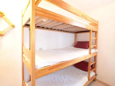 a couple of bunk beds in a room at Studio central village aux Carroz, animaux admis, 5 pers - FR-1-572-202 in Arâches-la-Frasse