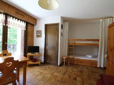 a living room with a desk and a bunk bed at Studio au pied des pistes avec terrasse – 4 pers, lave-vaisselle & lave-linge - FR-1-572-135 in Arâches-la-Frasse