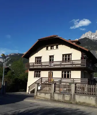 a large white house with a fence in front of it at Chambres à Sallanches in Sallanches