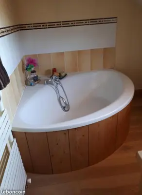 a bath tub with a faucet in a bathroom at Chambres à Sallanches in Sallanches