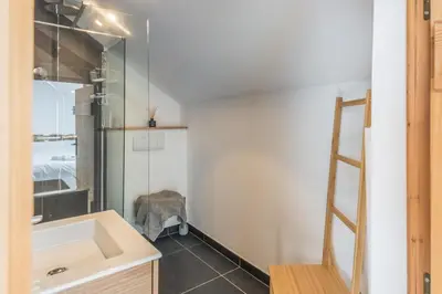 a bathroom with a sink and a mirror at Appartement Soffitta - Welkeys in Chamonix-Mont-Blanc
