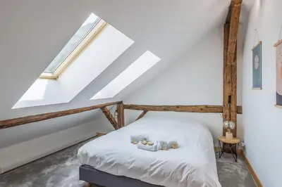 a bedroom with a bed in a attic at Appartement Soffitta - Welkeys in Chamonix-Mont-Blanc