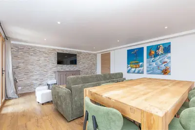 a living room with a couch and a wooden table at Chalet Nessa in Combloux