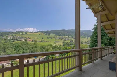 a balcony with a view of the mountains at Chalet Nessa in Combloux