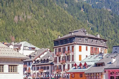a group of buildings in front of a mountain at Appartement Lyret - Welkeys in Chamonix-Mont-Blanc