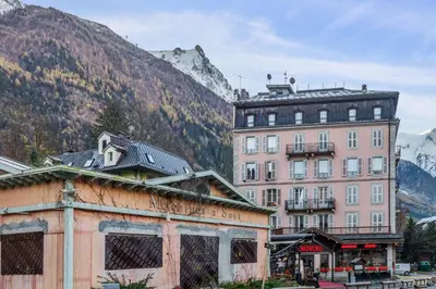 a group of buildings in front of a mountain at Appartement Lyret - Welkeys in Chamonix-Mont-Blanc