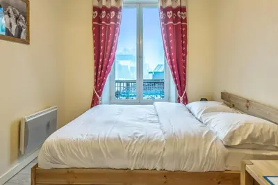 a bedroom with two beds and a window at Appartement Lyret - Welkeys in Chamonix-Mont-Blanc