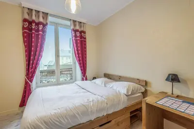 a bedroom with a bed and a window at Appartement Lyret - Welkeys in Chamonix-Mont-Blanc