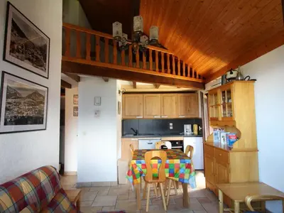 a kitchen with a table with chairs and a dining room at Appartement cosy 6 pers. au pied des pistes, balcon sud-ouest, proche centre, ski-in/ski-out - FR-1-572-155 in Arâches-la-Frasse