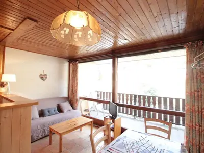 a living room with a couch and a table at Studio 4 pers, centre village, 450m télécabine, balcon, casier à skis, animaux acceptés - FR-1-572-211 in Arâches-la-Frasse