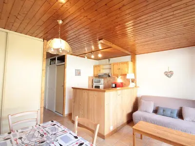 a living room with a couch and a table at Studio 4 pers, centre village, 450m télécabine, balcon, casier à skis, animaux acceptés - FR-1-572-211 in Arâches-la-Frasse
