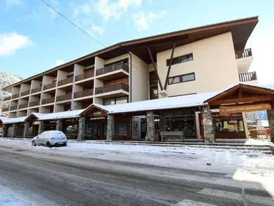 a building with a car parked in front of it at Studio 4 pers, centre village, 450m télécabine, balcon, casier à skis, animaux acceptés - FR-1-572-211 in Arâches-la-Frasse