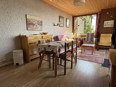 a dining room with a table and chairs at Chalet 3 chambres, 8 pers, terrasse sud, proche remontées, équipements complets - FR-1-572-216 in Arâches-la-Frasse