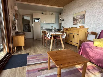 a living room with a table and a kitchen at Chalet 3 chambres, 8 pers, terrasse sud, proche remontées, équipements complets - FR-1-572-216 in Arâches-la-Frasse