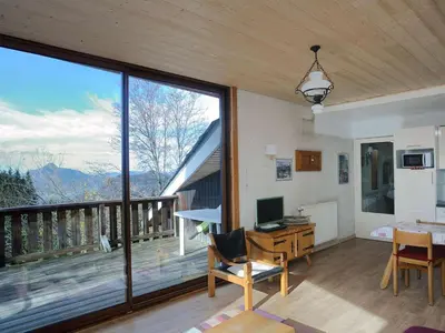 a room with a desk with a computer and a balcony at Chalet 3 chambres, 8 pers, terrasse sud, proche remontées, équipements complets - FR-1-572-216 in Arâches-la-Frasse