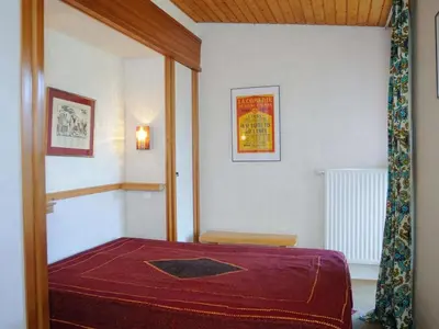 a bedroom with a bed with a red blanket at Chalet 3 chambres, 8 pers, terrasse sud, proche remontées, équipements complets - FR-1-572-216 in Arâches-la-Frasse