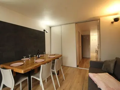a dining room with a table and a couch at Appartement rénové 3 pièces - 6 pers - Balcon Sud - Résidence Sirius à Flaine Forêt - FR-1-687-5 in Arâches-la-Frasse