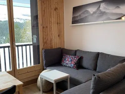 a living room with a couch and a table at Studio rénové à Flaine Forêt - 5 pers, proche des pistes et commerces, balcon sud, casier à skis - FR-1-687-24 in Arâches-la-Frasse
