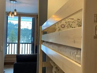 a room with a wooden staircase with a balcony at Studio rénové à Flaine Forêt - 5 pers, proche des pistes et commerces, balcon sud, casier à skis - FR-1-687-24 in Arâches-la-Frasse