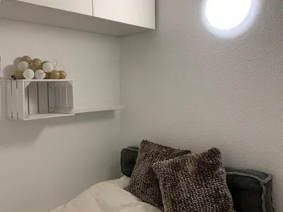 a room with a bed with pillows and a shelf at Studio rénové à Flaine Forêt - 5 pers, proche des pistes et commerces, balcon sud, casier à skis - FR-1-687-24 in Arâches-la-Frasse