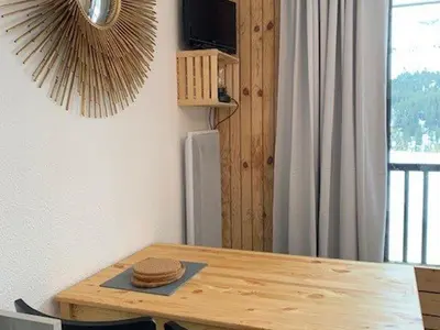 a wooden table in a room with a tableablish at Studio rénové à Flaine Forêt - 5 pers, proche des pistes et commerces, balcon sud, casier à skis - FR-1-687-24 in Arâches-la-Frasse