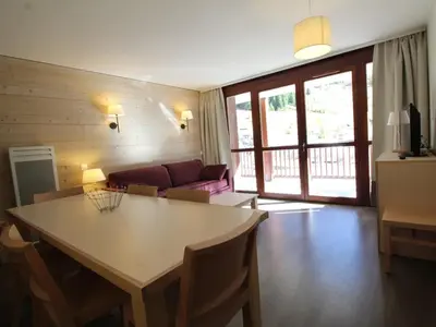 a living room with a table and a couch at Flaine: 4P au pied des pistes, piscine, parking, 8 pers - FR-1-687-15 in Arâches-la-Frasse