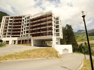a large white building on a hill with a street light at Flaine: 4P au pied des pistes, piscine, parking, 8 pers - FR-1-687-15 in Arâches-la-Frasse
