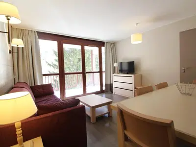 a living room with a couch and a table at Flaine: 4P au pied des pistes, piscine, parking, 8 pers - FR-1-687-15 in Arâches-la-Frasse