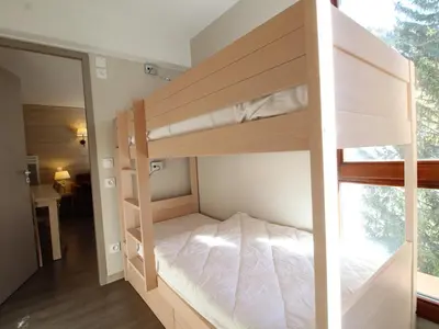 a bedroom with two bunk beds and a mirror at Flaine: 4P au pied des pistes, piscine, parking, 8 pers - FR-1-687-15 in Arâches-la-Frasse